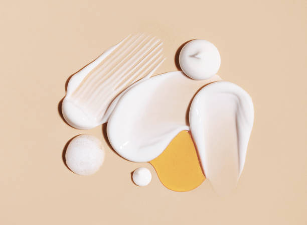 cosmetic smears of creamy texture on a beige background